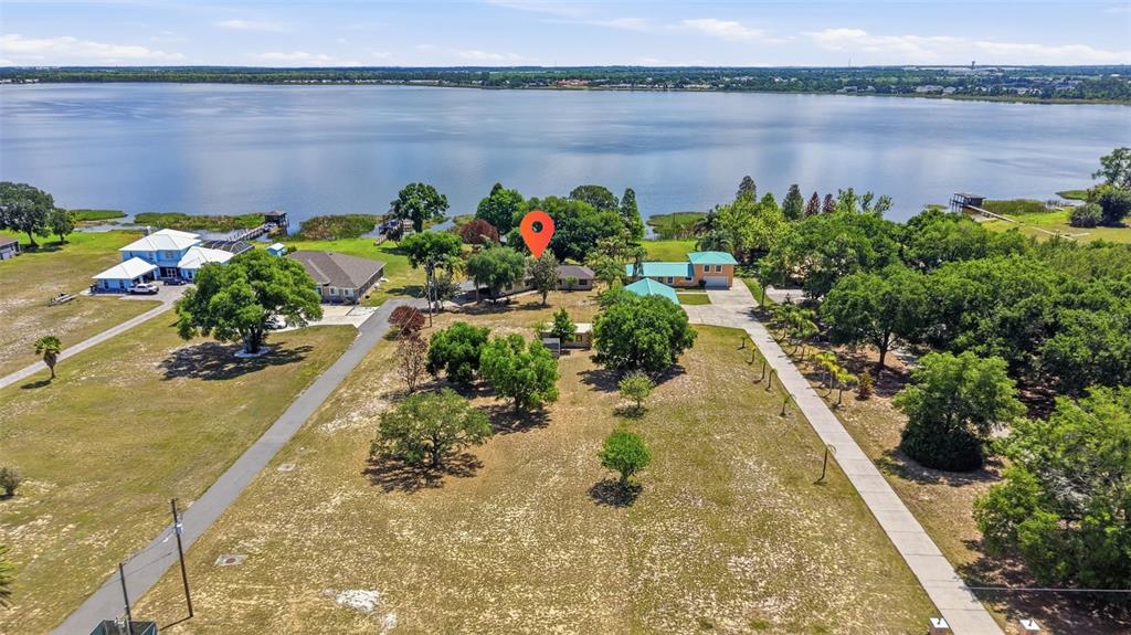 An aerial view shows a house with a red location pin near a large lake — 410 S RAMONA AVENUE, LAKE ALFRED, FL