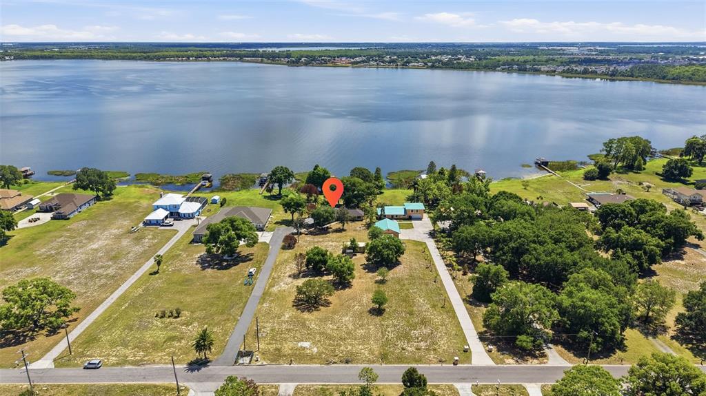 An aerial view shows a house with a red location pin beside a large lake — 410 S RAMONA AVENUE, LAKE ALFRED, FL