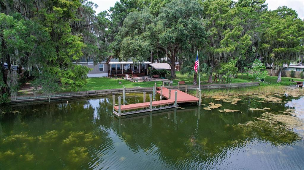 An aerial view of a waterfront house with a wooden dock and a large lawn — 9065 W LAKEVIEW COURT, CRYSTAL RIVER, FL