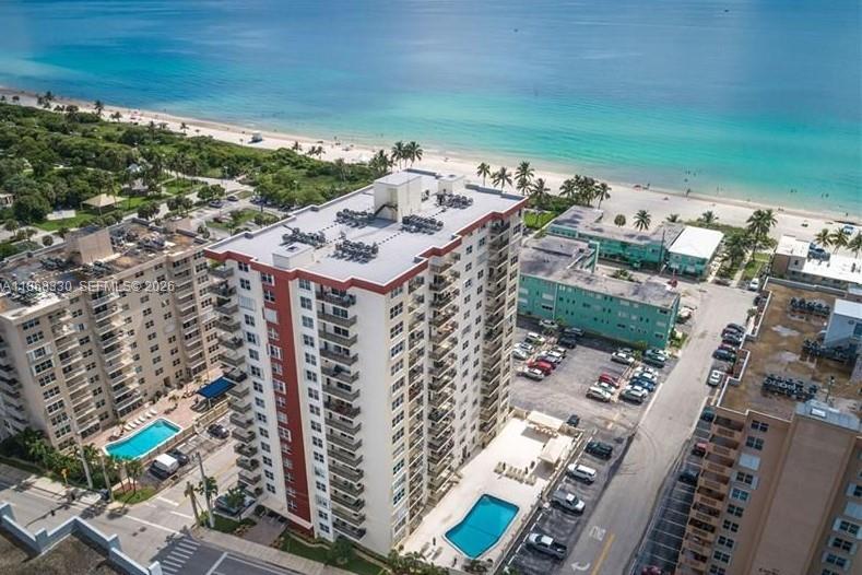 An aerial view shows a tall residential building with a pool near the beach — 1501 S Ocean Dr # 201, Hollywood FL 33019, HOLLYWOOD, FL