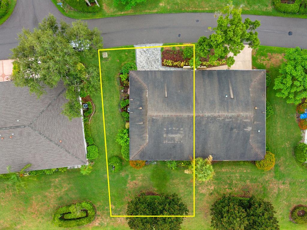 An aerial view shows a house with a dark roof and a highlighted rectangular yard — 1409 LANGLEY DRIVE UNIT 1409, SUN CITY CENTER, FL