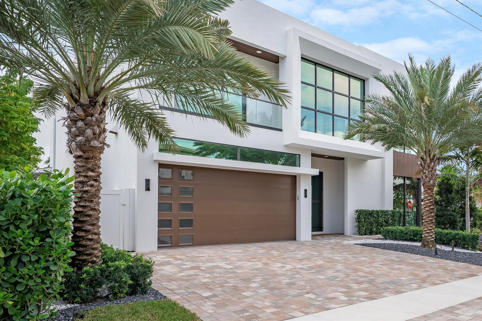 A modern two-story house with a brown garage door, large windows, and two palm trees — 400 NE 4th Street, Boca Raton FL 33432, BOCA RATON, FL