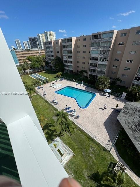 An elevated view shows a swimming pool surrounded by a patio and a large apartment building — 319 NE 14th Ave # 607, Hallandale Beach FL 33009, HALLANDALE BEACH, FL