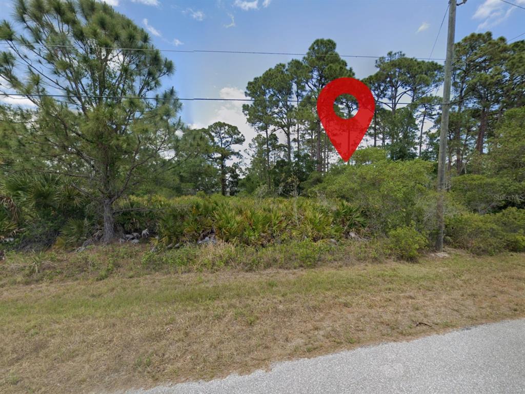 A red location pin marks a wooded, undeveloped lot next to a paved road — 18090 SICILY AVENUE, PORT CHARLOTTE, FL