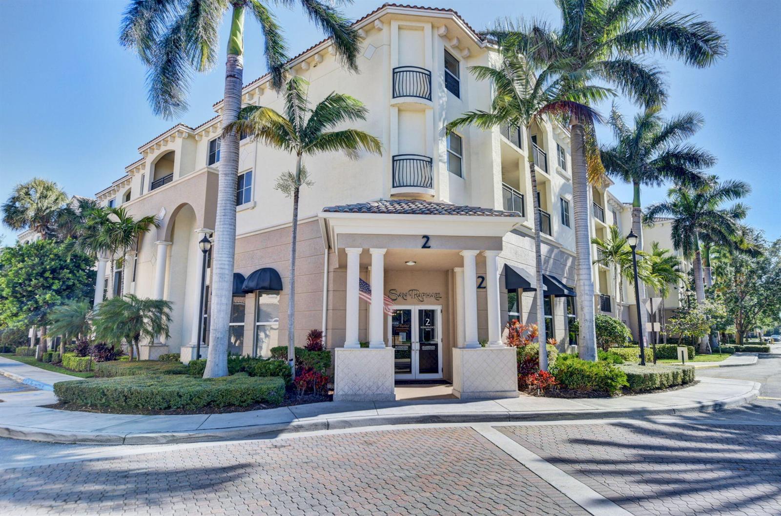 A multi-story residential building with a covered entrance, palm trees, and a brick driveway — 3110 Renaissance Way # 110, Boynton Beach FL 33426, BOYNTON BEACH, FL