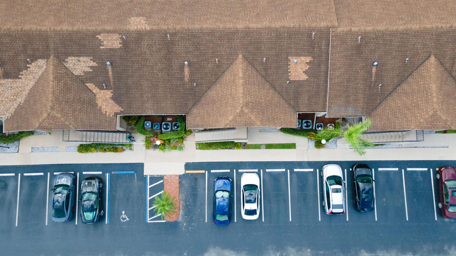 An aerial view shows a building with a brown shingled roof and a parking lot — 9467 Boca Cove Circle # 804, Boca Raton FL 33428, BOCA RATON, FL