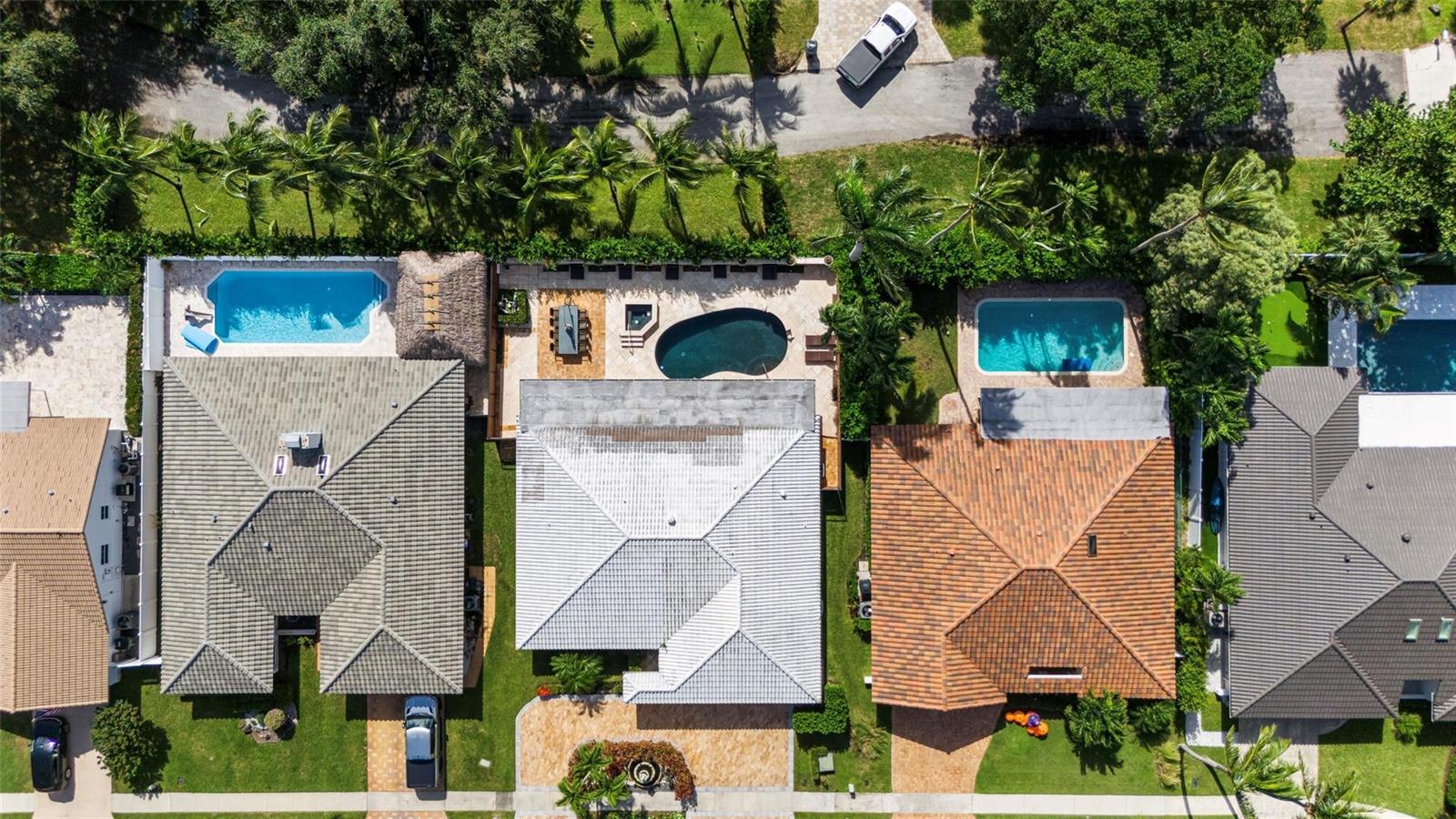 An aerial view shows four residential houses with swimming pools and landscaped backyards — 5223 Deerhurst Crescent Circle, Boca Raton FL 33486, BOCA RATON, FL