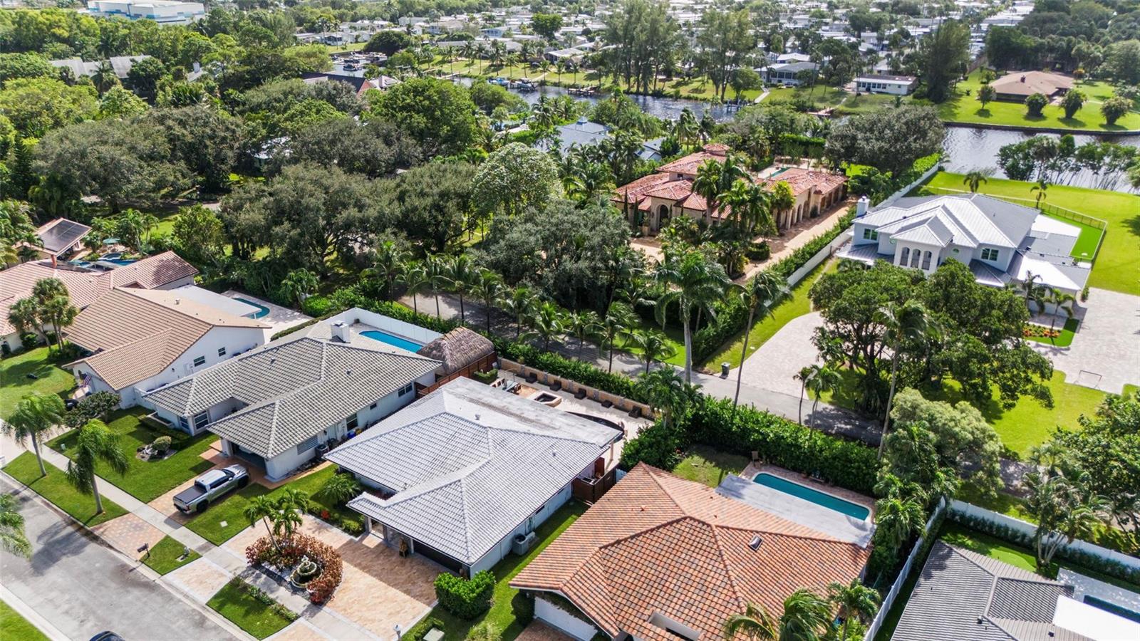 An aerial view shows several suburban houses with swimming pools and lush landscaping — 5223 Deerhurst Crescent Circle, Boca Raton FL 33486, BOCA RATON, FL