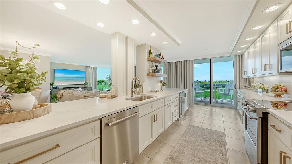 A bright kitchen with white cabinets, stainless steel appliances, and a view of the ocean — 2425 GULF OF MEXICO DRIVE UNIT 1B, LONGBOAT KEY, FL