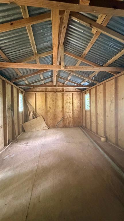 An interior view of a wooden shed with exposed rafters and a corrugated metal roof — CAIN ALTO. BO. HOCONUCO ALTO, SAN GERMAN, PR