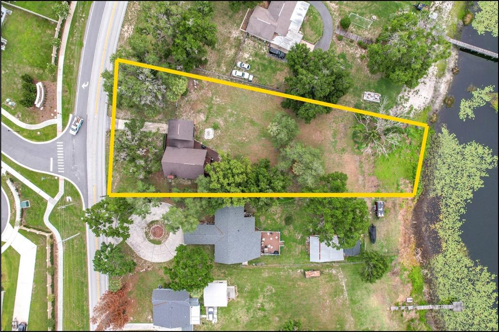 An aerial view shows a residential property outlined in yellow, featuring a house and waterfront — 4840 OLD LUCERNE PARK RD, WINTER HAVEN, FL
