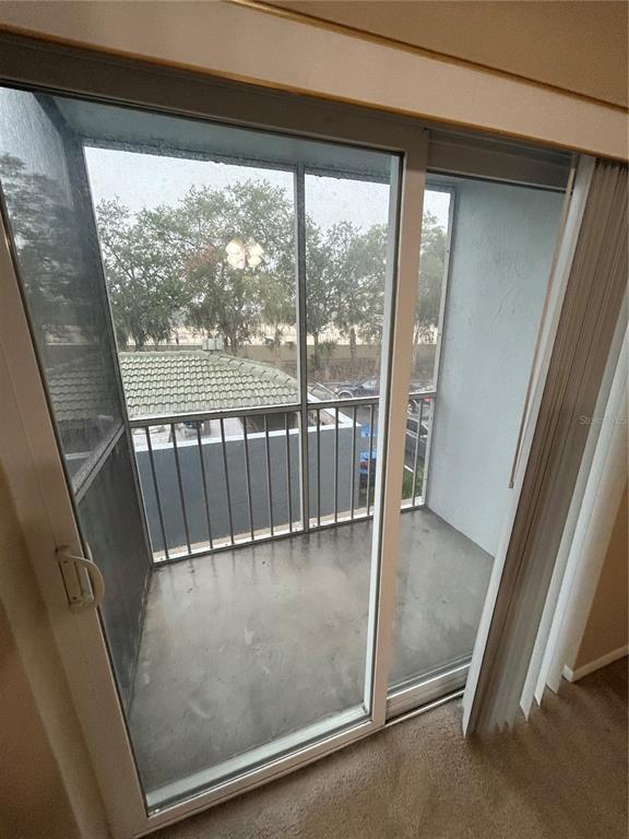 A sliding glass door opens onto a small, screened-in balcony with a concrete floor — 109 OYSTER BAY CIRCLE UNIT 240, ALTAMONTE SPRINGS, FL