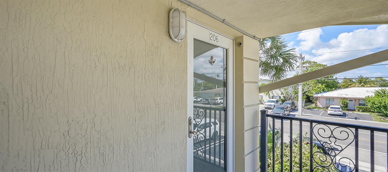 A view from a balcony looking at the entrance door of unit 206 — 410 SW 15th Street # 206, Pompano Beach FL 33060, POMPANO BEACH, FL