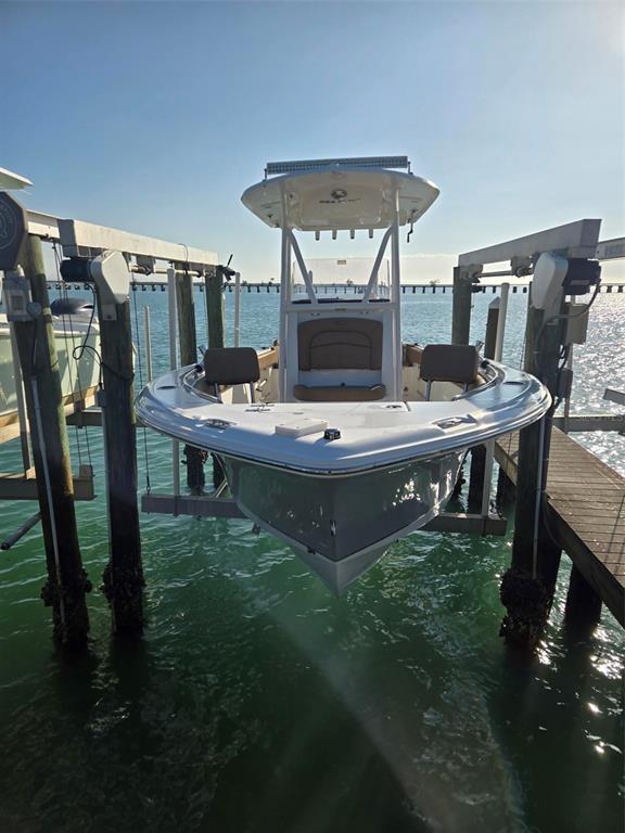 A center console boat is suspended on a lift above the water — 6040 BOCA GRANDE CAUSEWAY UNIT 03 Boat Slip, BOCA GRANDE, FL