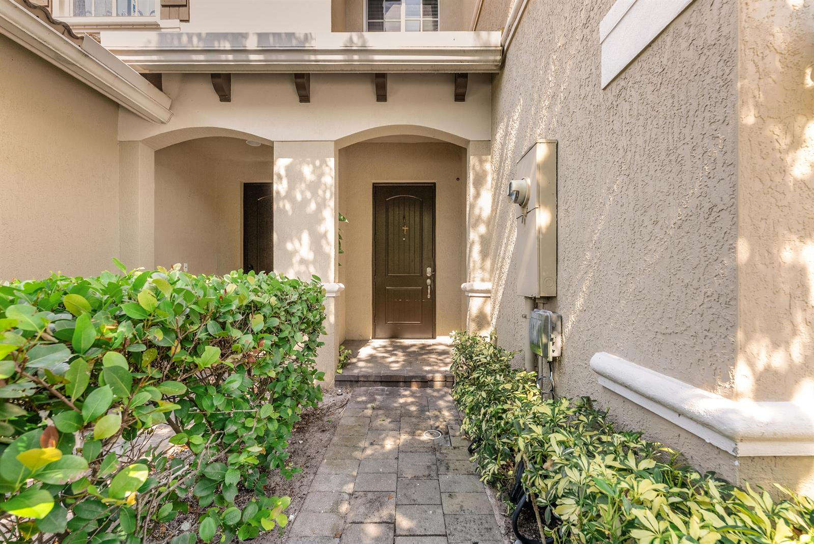 A paved walkway leads to a dark front door recessed under a covered entryway — 354 SE 1st Way # 354, Deerfield Beach FL 33441, DEERFIELD BEACH, FL