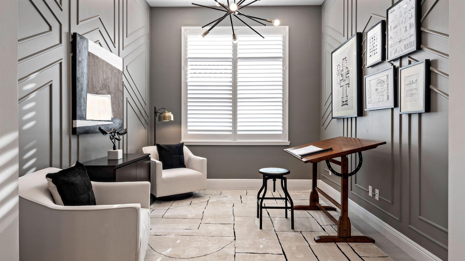A home office features gray paneled walls, a drafting table, two armchairs, and a rug — 5627 Saint Armands Way, Westlake FL 33470, WESTLAKE, FL