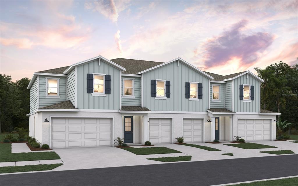 A digital rendering of a three-unit townhouse complex with light blue siding and white brick — 31661 OCEAN BREEZE DRIVE, SAN ANTONIO, FL