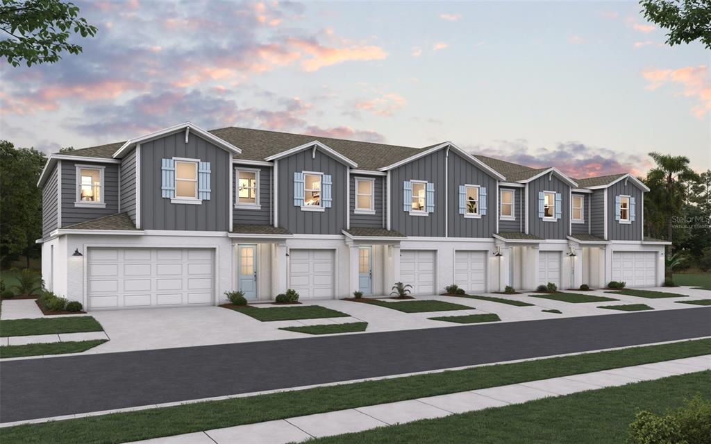 A digital rendering of a multi-unit townhouse building with gray siding and white garage doors — 31661 OCEAN BREEZE DRIVE, SAN ANTONIO, FL