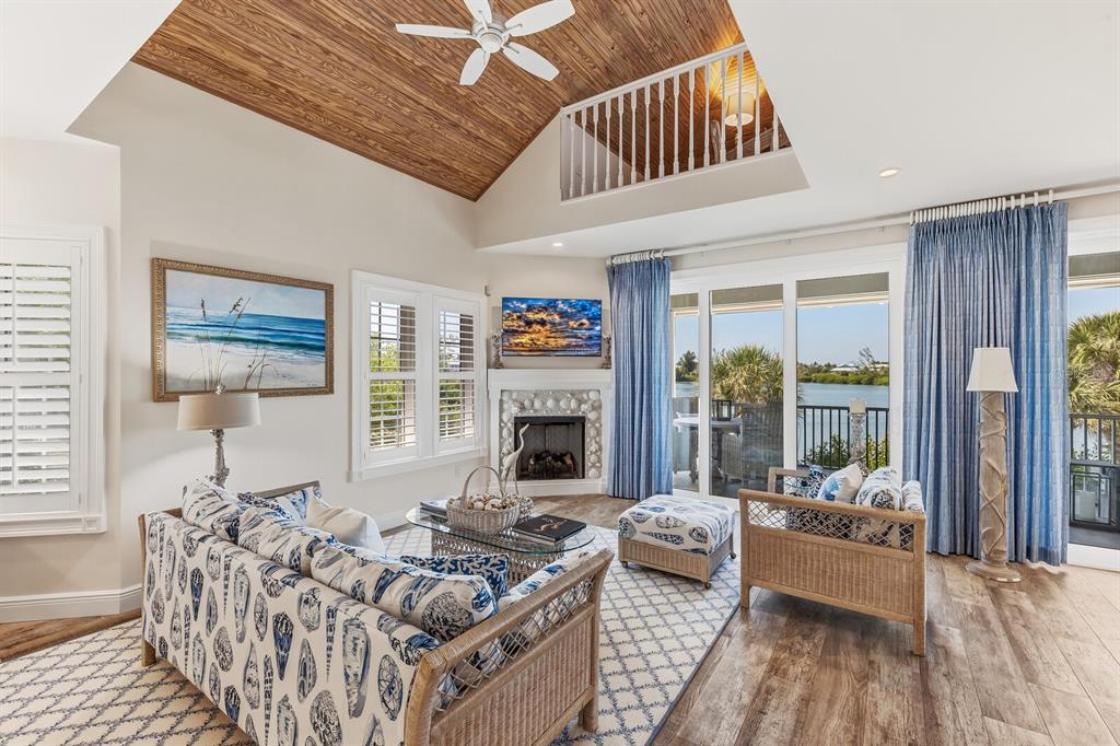 A three-story house with a metal roof, white trim, and a paved driveway — 40 SEAWATCH LAKE DRIVE, BOCA GRANDE, FL