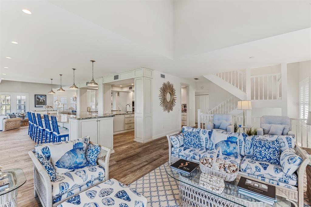 A living room features a vaulted wood-paneled ceiling, a shell-covered fireplace, and coastal-themed furniture — 40 SEAWATCH LAKE DRIVE, BOCA GRANDE, FL