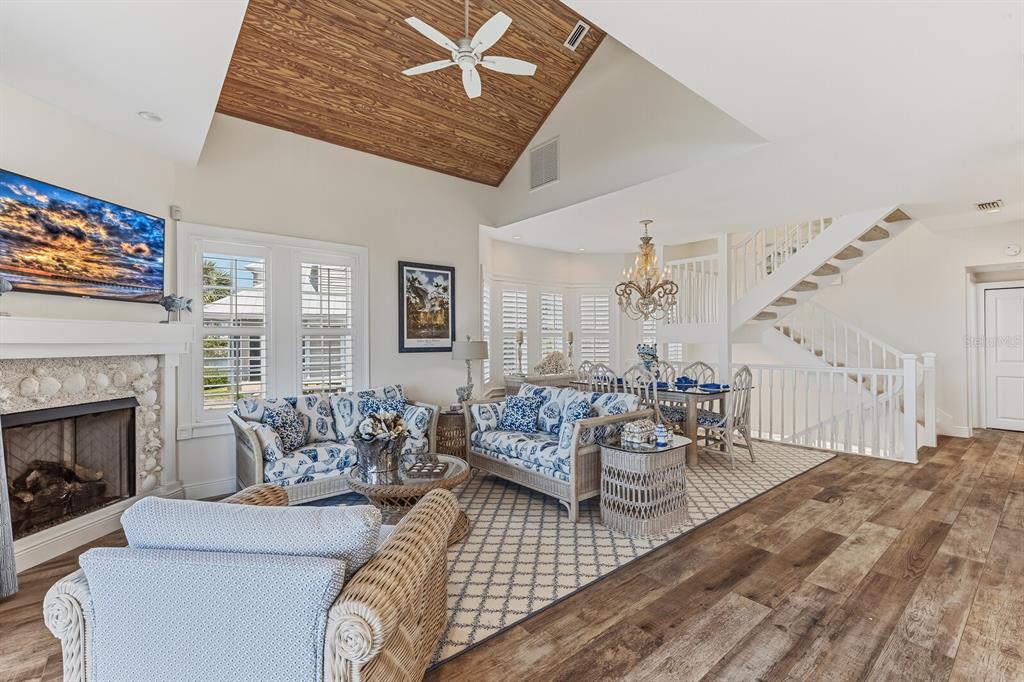 A bright living room and kitchen area features blue and white coastal-themed furniture and decor — 40 SEAWATCH LAKE DRIVE, BOCA GRANDE, FL