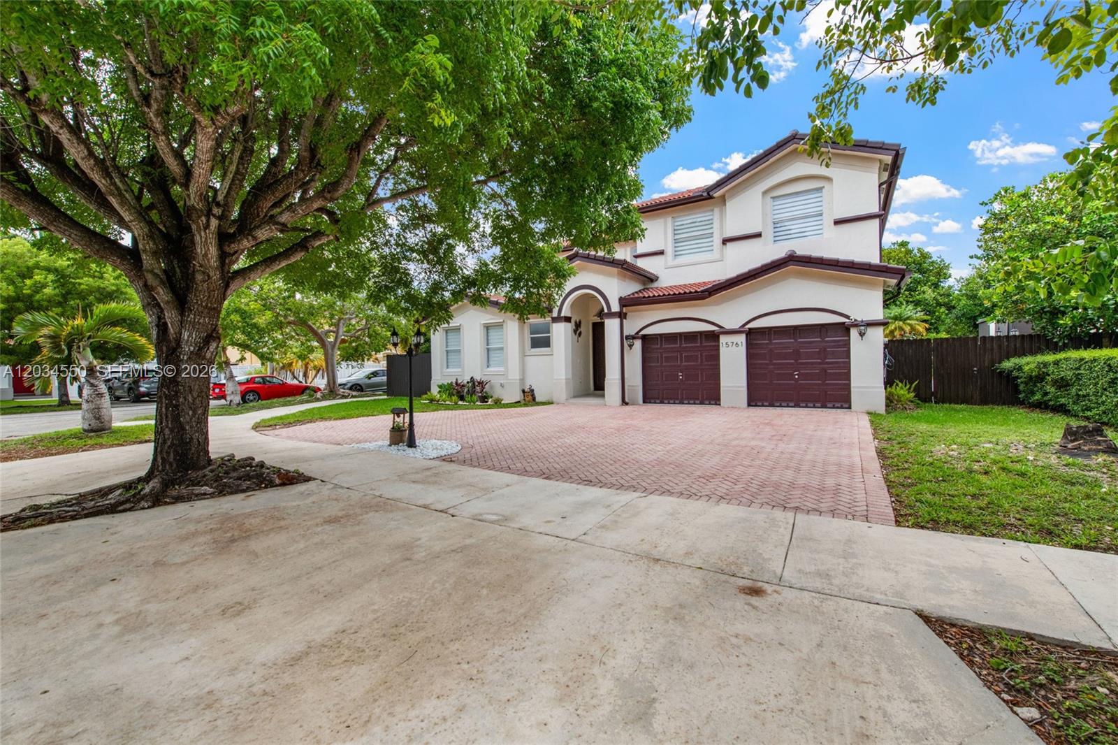 A two-story house with a brick driveway, a two-car garage, and a large tree — 15761 SW 59th Ter, Miami FL 33193, MIAMI, FL