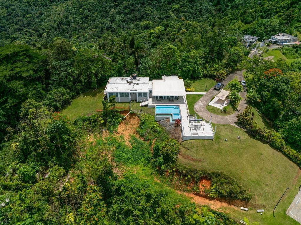 An aerial view of a house with a swimming pool and patio on a hillside — PR 797 km 5.3 JAGUEYES WARD, AGUAS BUENAS, PR