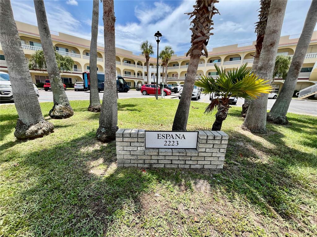 A brick sign for a residential complex stands in front of palm trees and buildings — 2223 PHILIPPINE DRIVE UNIT 9, CLEARWATER, FL