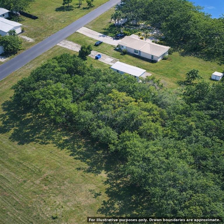 An aerial view shows a house, a detached structure, and a large wooded area — FLAMINGO ROAD, OAK HILL, FL