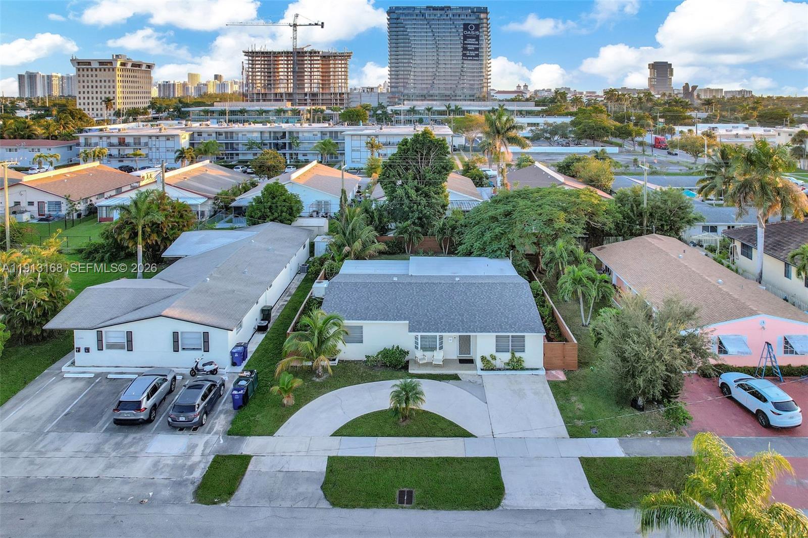 An aerial view shows a single-story house with a gray roof and a circular driveway — 1012 NE 2nd Street, Hallandale Beach FL 33009, HALLANDALE BEACH, FL