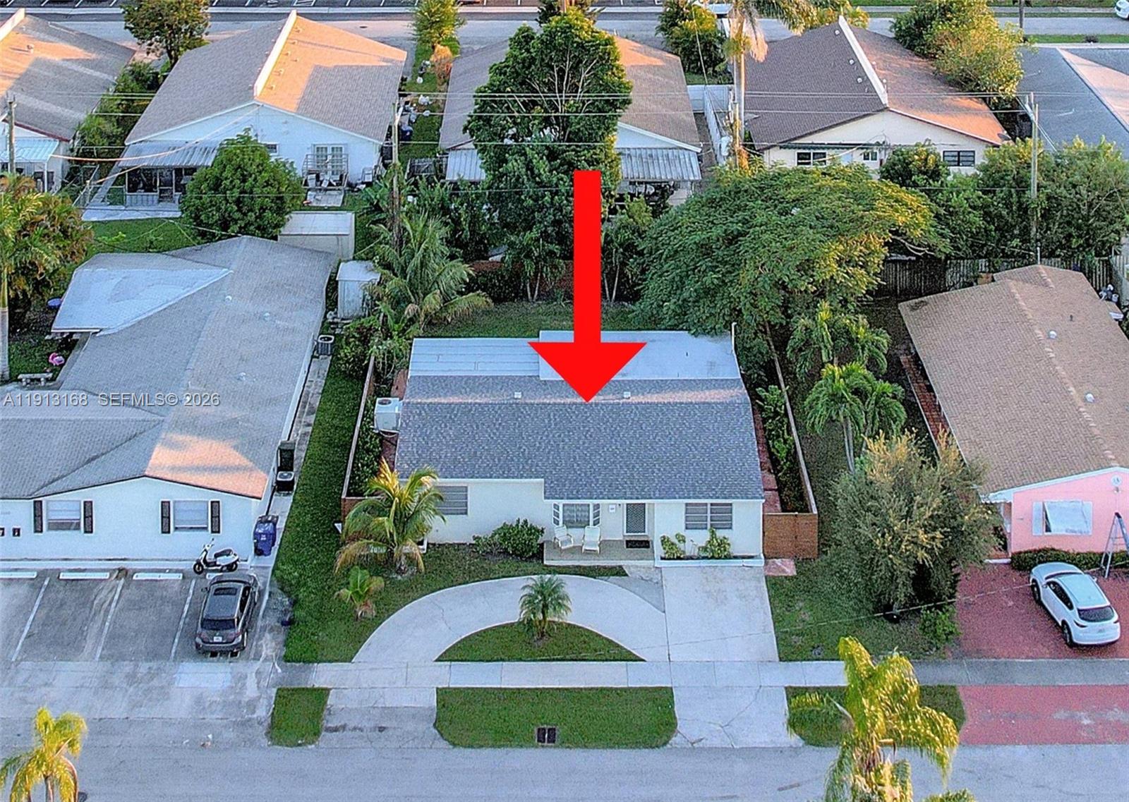 An aerial view shows a single-story house with a gray roof and a curved driveway — 1012 NE 2nd Street, Hallandale Beach FL 33009, HALLANDALE BEACH, FL