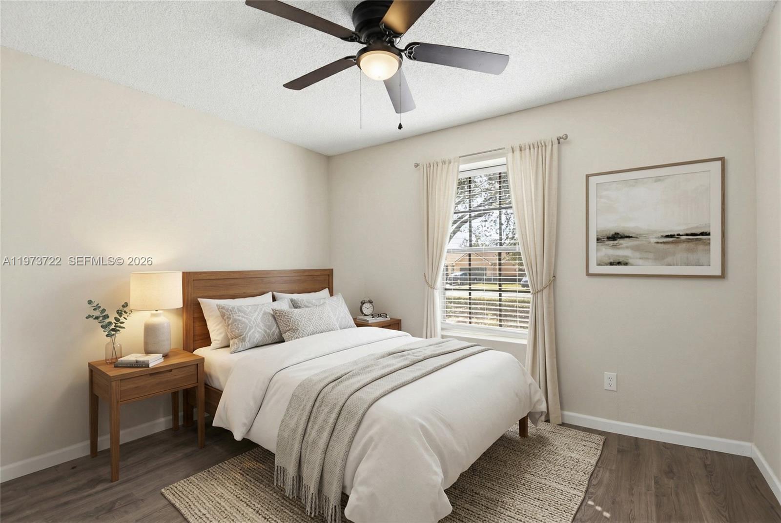A bedroom features a wooden bed frame, a ceiling fan, and a window with curtains — 637 Mosquero Ave, Deltona FL 32738, DELTONA, FL