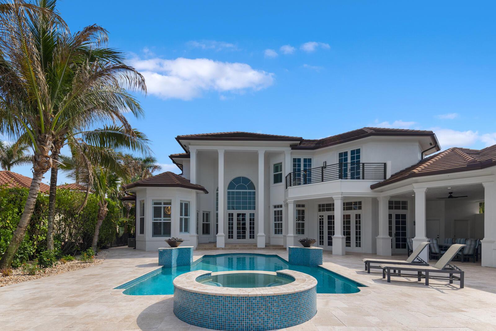 A two-story white house with a swimming pool, hot tub, and palm trees — 8709 SE Compass Island Way, Jupiter FL 33458, JUPITER, FL