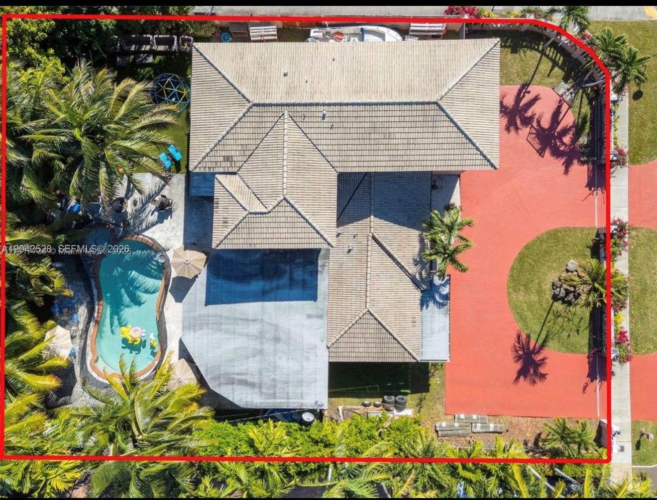 An aerial view shows a house with a tiled roof, a swimming pool, and red driveway — 3135 SW 80th Ave, Miami FL 33155, MIAMI, FL