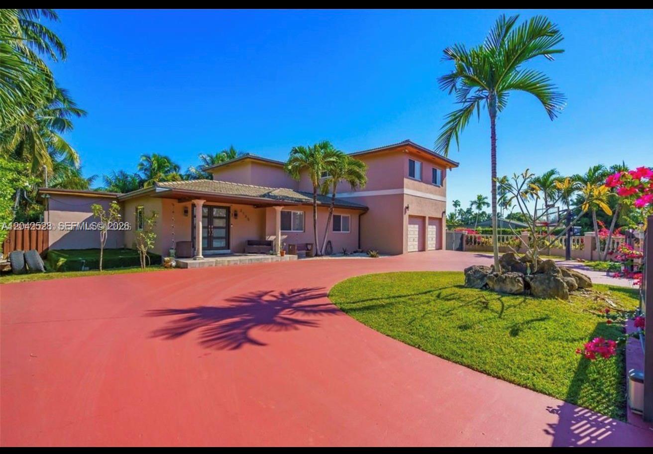 A two-story house with a red circular driveway and palm trees under a clear sky — 3135 SW 80th Ave, Miami FL 33155, MIAMI, FL