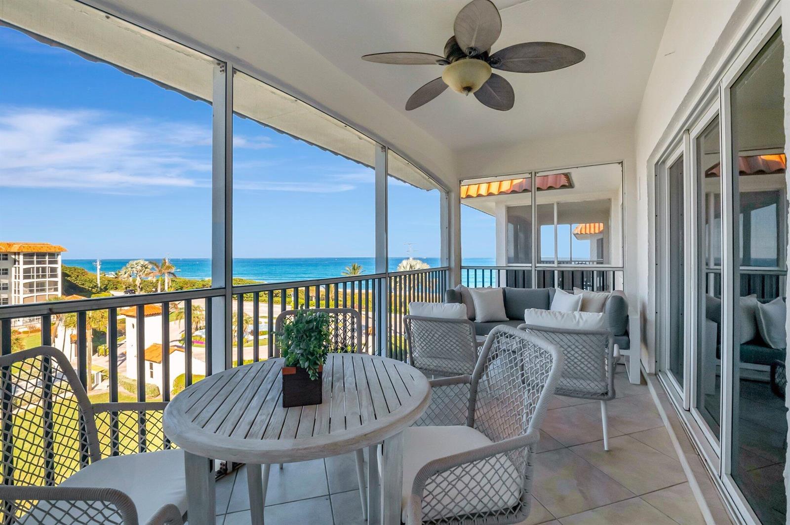 A screened-in balcony features outdoor furniture, a ceiling fan, and a view of the ocean — 2871 N Ocean Boulevard # D506, Boca Raton FL 33431, BOCA RATON, FL