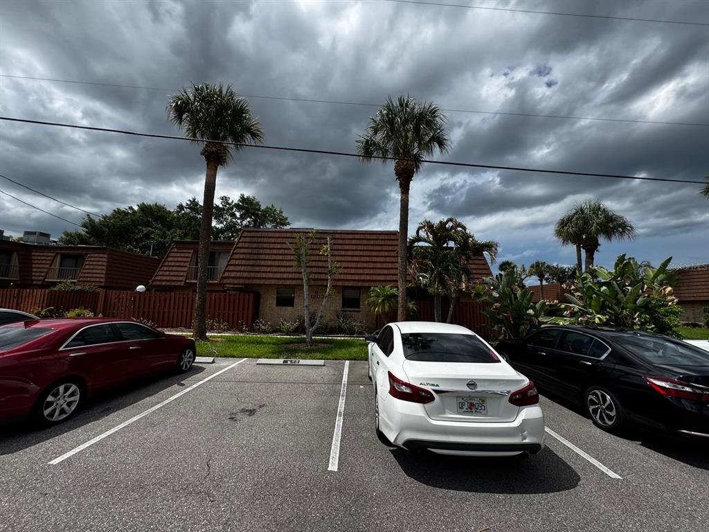 A parking lot sits in front of a two-story building with a brown tiled roof — 1302 NEBRASKA AVENUE UNIT 6A, FORT PIERCE, FL