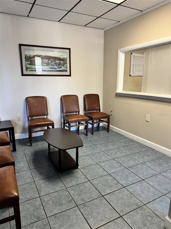 A waiting room features brown chairs, a small coffee table, and tiled flooring — 2226 E SILVER SPRINGS BOULEVARD UNIT Suite C, OCALA, FL