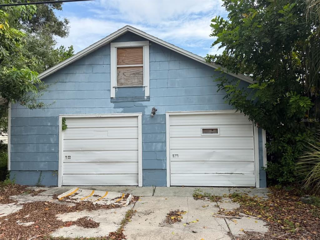A detached two-car garage with blue siding and a boarded-up window in the gable — 4227 2ND AVENUE S, ST PETERSBURG, FL