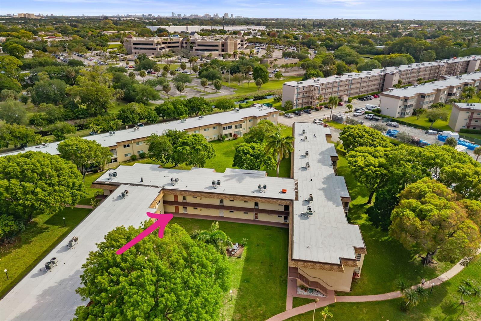 An aerial view shows a multi-story apartment building with a flat roof and surrounding landscaping — 752 Lori Drive # 219, Palm Springs FL 33461, PALM SPRINGS, FL