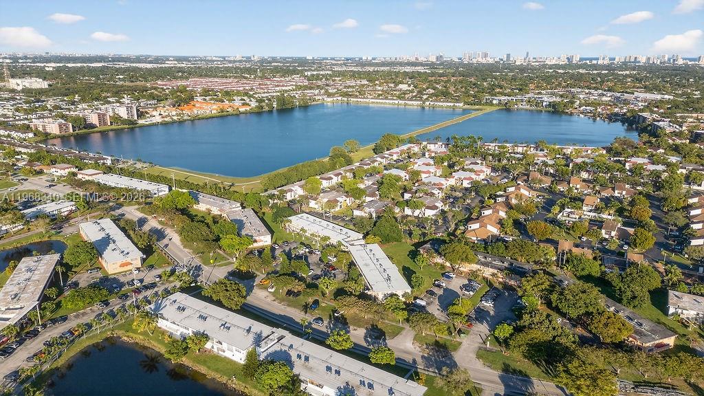 An aerial view shows a residential apartment complex situated next to a large lake — 20311 NE 2nd Ave # 15, Miami FL 33179, MIAMI, FL