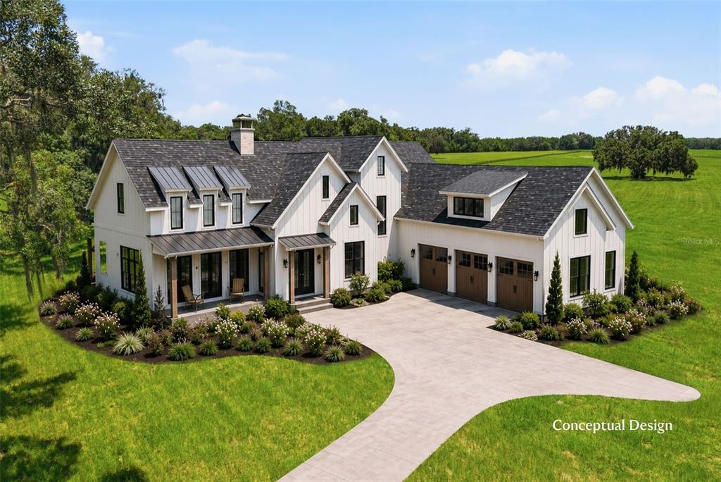 This is a conceptual design rendering of a white farmhouse with a three-car garage — TBD (Lot 14-W) SW 138TH LOOP, DUNNELLON, FL