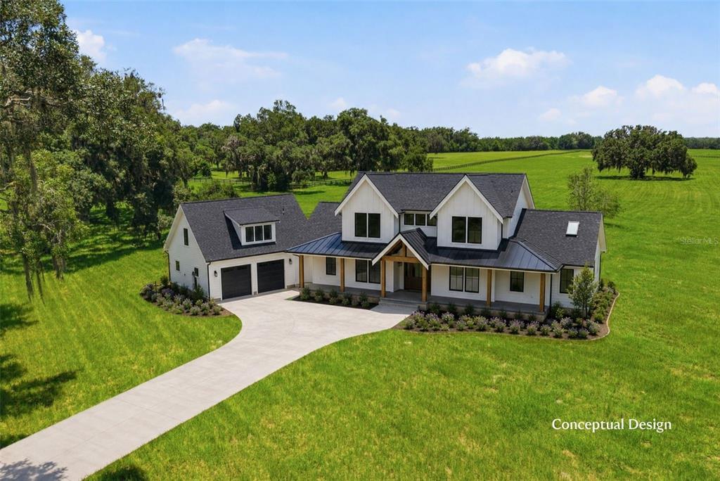 This is a digital rendering of a modern farmhouse with a metal roof and porch — TBD (Lot 14-W) SW 138TH LOOP, DUNNELLON, FL