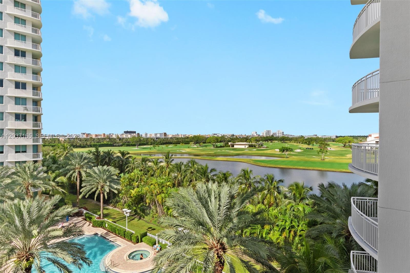An elevated view shows a swimming pool, palm trees, a lake, and a golf course — 1755 E Hallandale Beach Blvd # 501E, Hallandale Beach FL 33009, HALLANDALE BEACH, FL