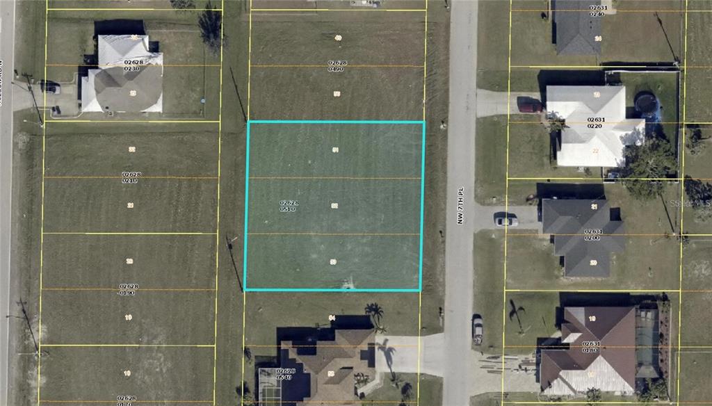 This is an aerial map showing a vacant residential lot highlighted in blue — 1012 NW 7TH PLACE, CAPE CORAL, FL