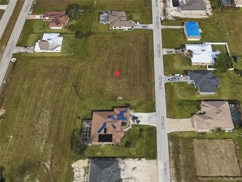 This aerial map shows a vacant residential lot marked with a red pin — 1012 NW 7TH PLACE, CAPE CORAL, FL