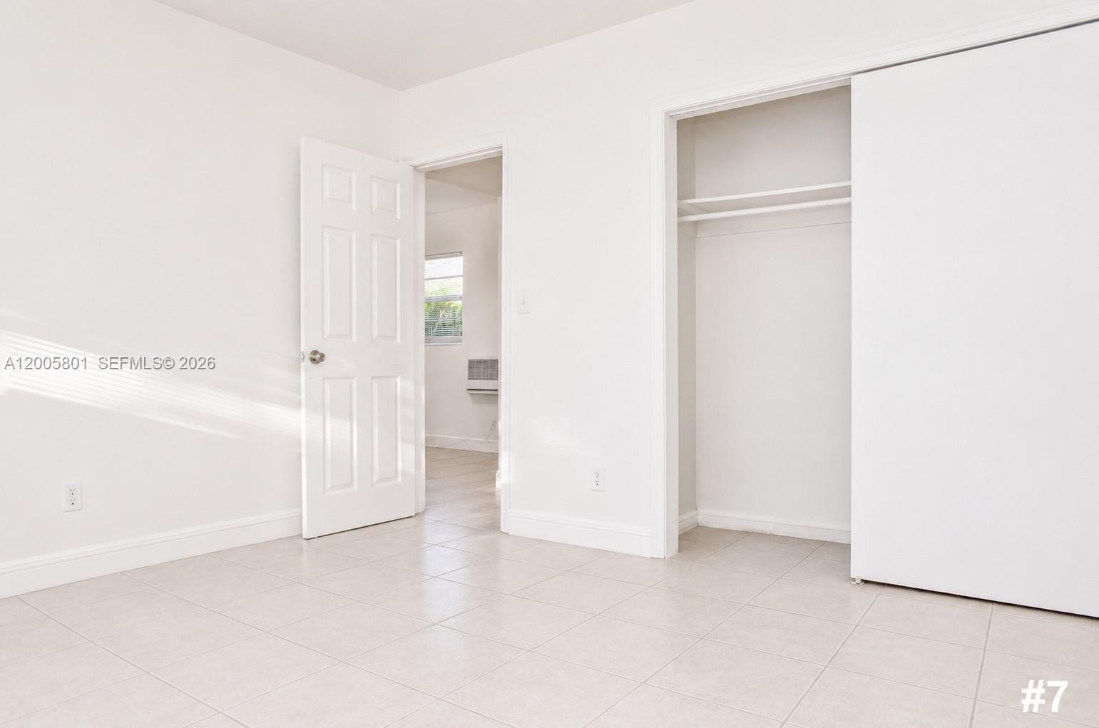 An empty room features white walls, tile flooring, an open doorway, and a closet — 2206 Fillmore St # 6, Hollywood FL 33020, HOLLYWOOD, FL
