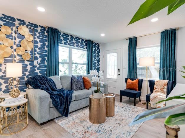 A modern kitchen features white cabinets, stainless steel appliances, and a patterned tile backsplash — 6225 76TH AVENUE N, PINELLAS PARK, FL