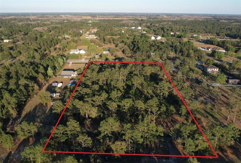 An aerial view shows a wooded, rectangular plot of land outlined in red — Lots 591-593 BANCROFT BOULEVARD, ORLANDO, FL
