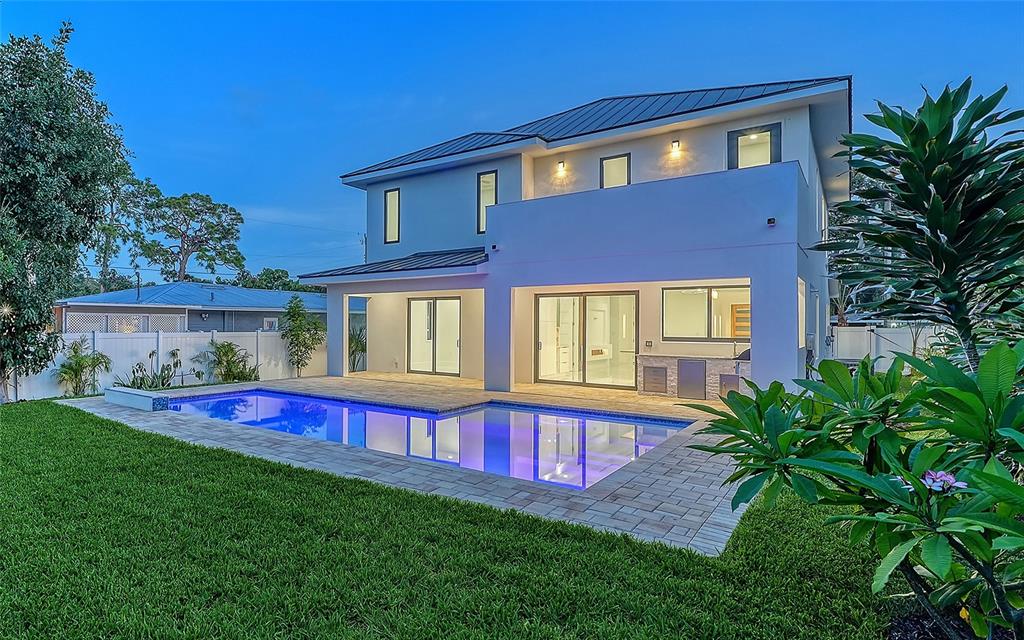 A modern two-story house with a swimming pool and patio in the backyard — 2483 BAY STREET, SARASOTA, FL